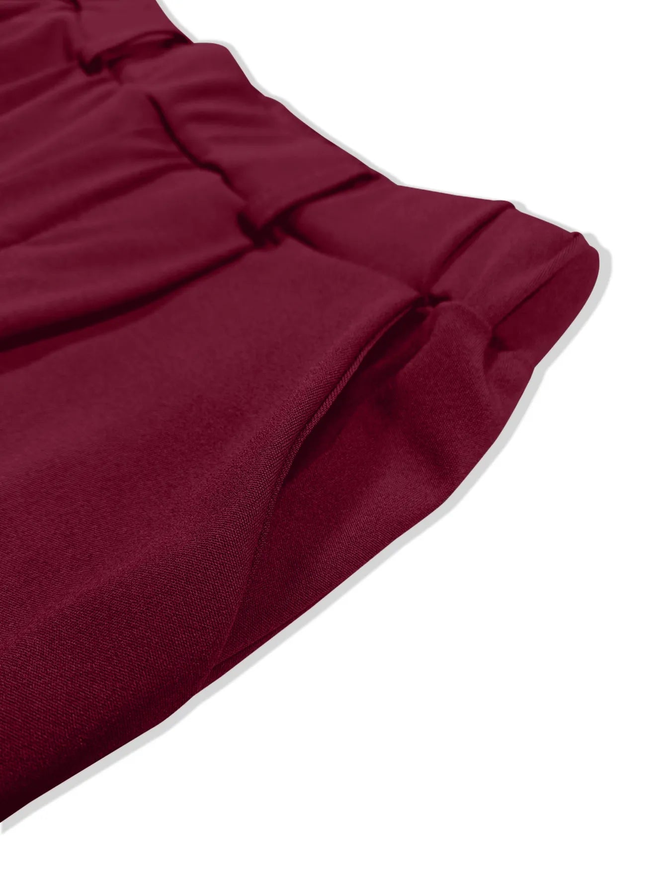 Burgundy pleated detail pants close-up with gathered fold and tapered leg