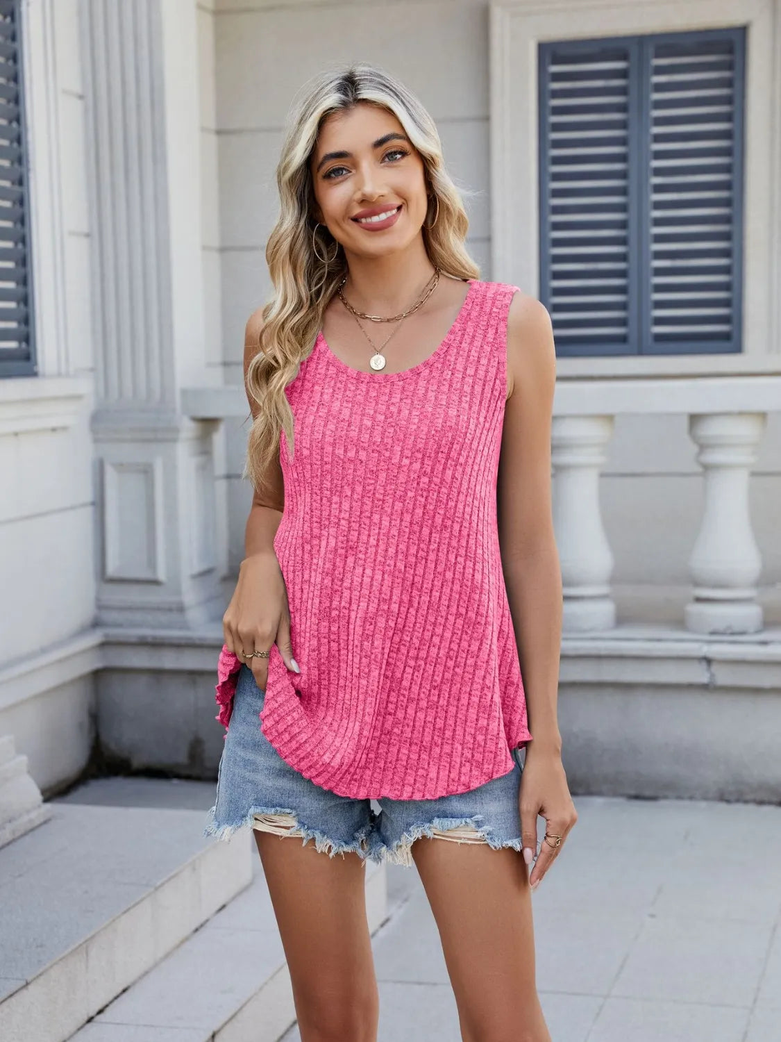 Hot pink ribbed round-neck tank with sleeveless design and side-curved hem