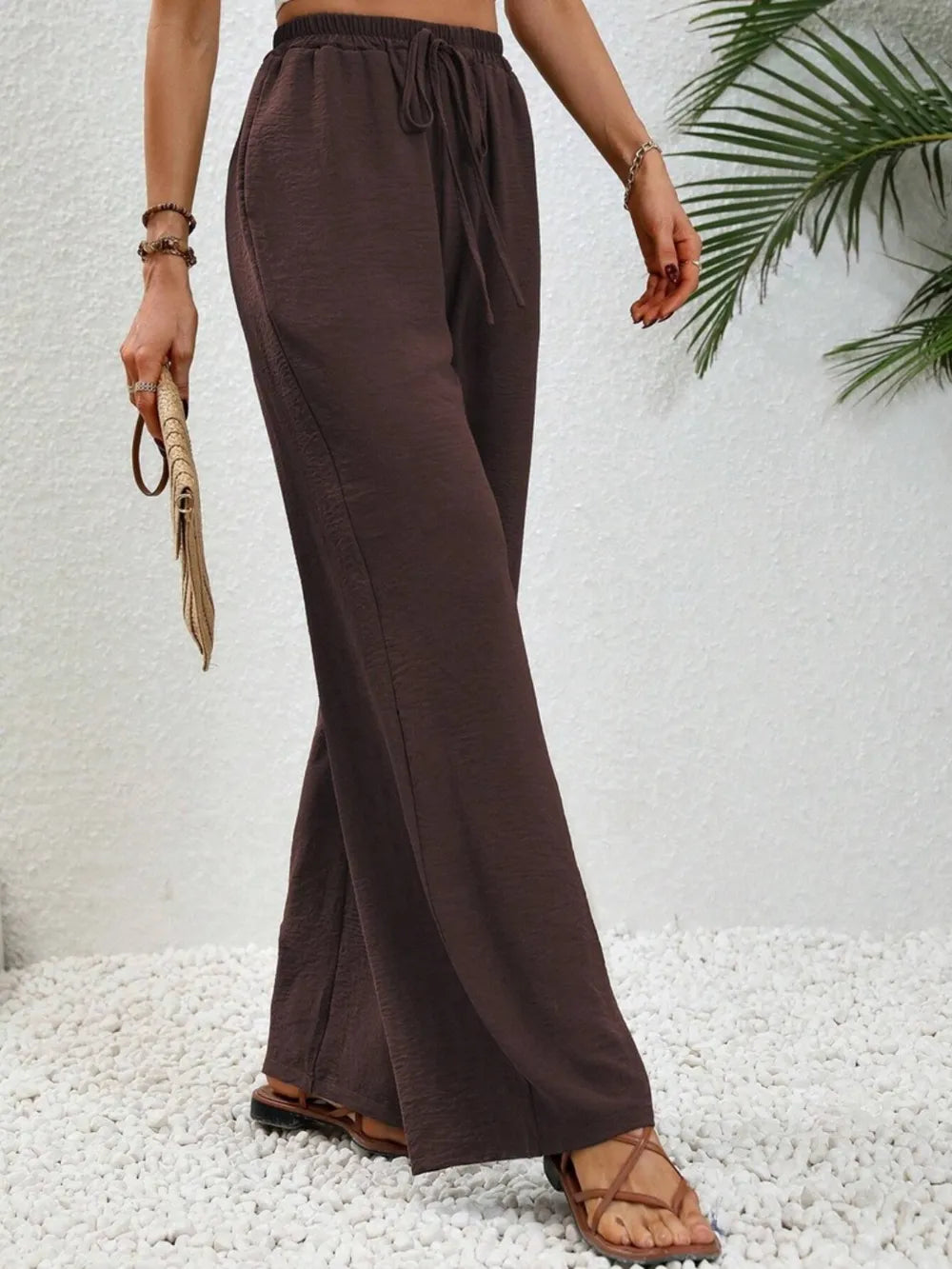 Dark brown wide-leg drawstring pants with elastic waistband and loose wide legs