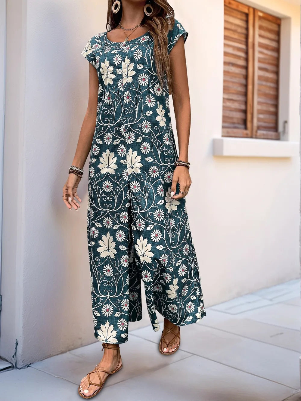 Dark teal printed wide-leg jumpsuit with round neckline and cap sleeves