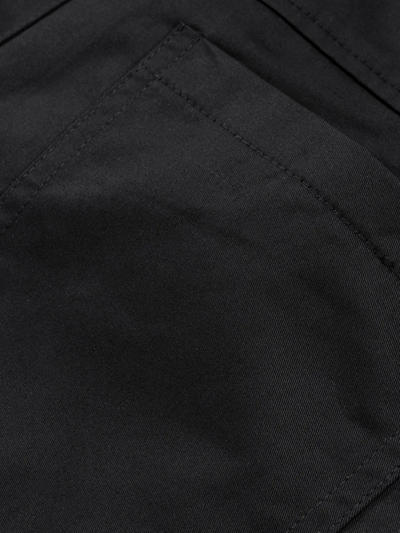 Men's black cargo pants fabric, diagonal seam and reinforced stitching close-up