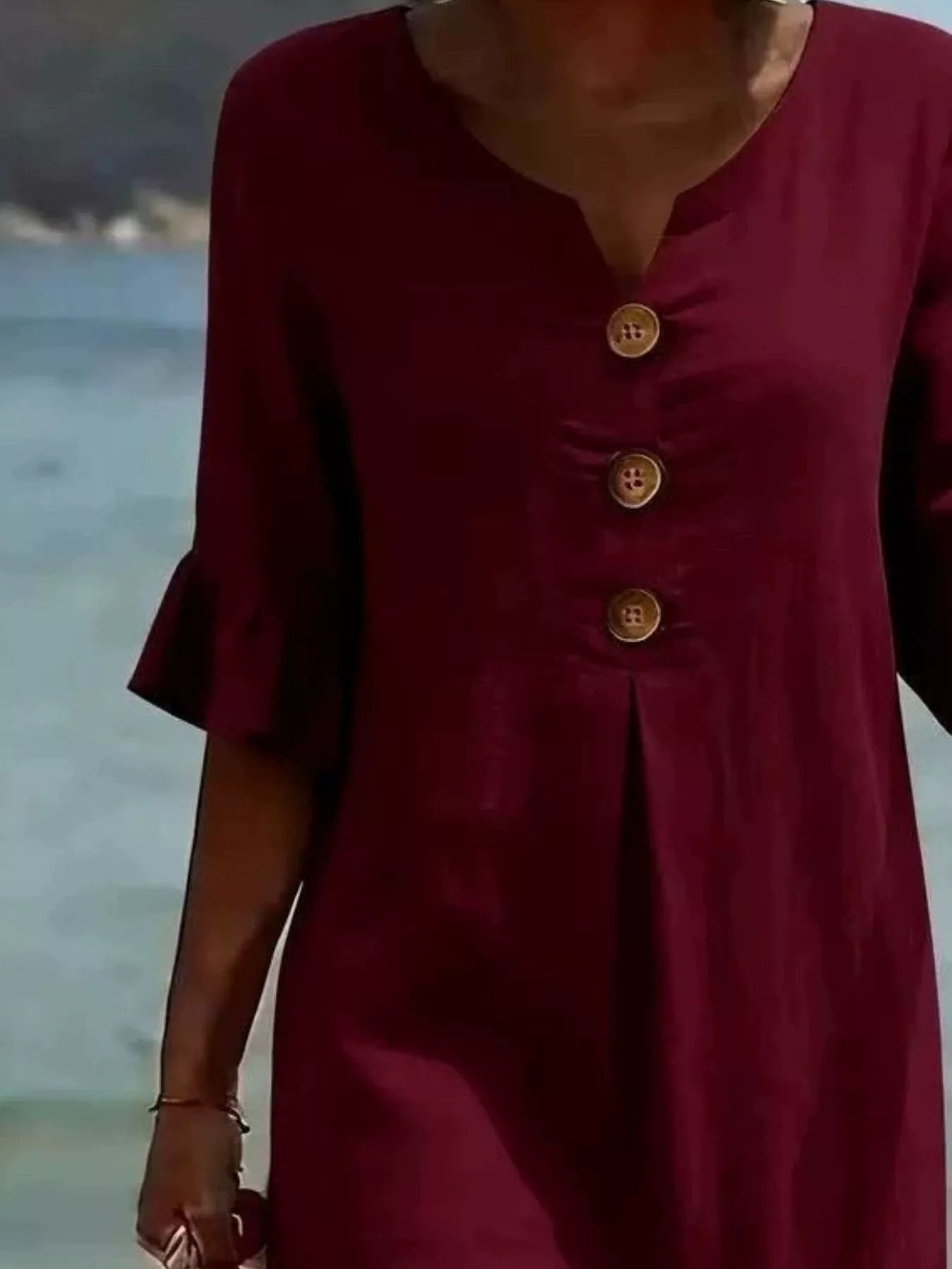 Burgundy V-neck button-front midi dress with ruffle sleeves and three wood-tone buttons