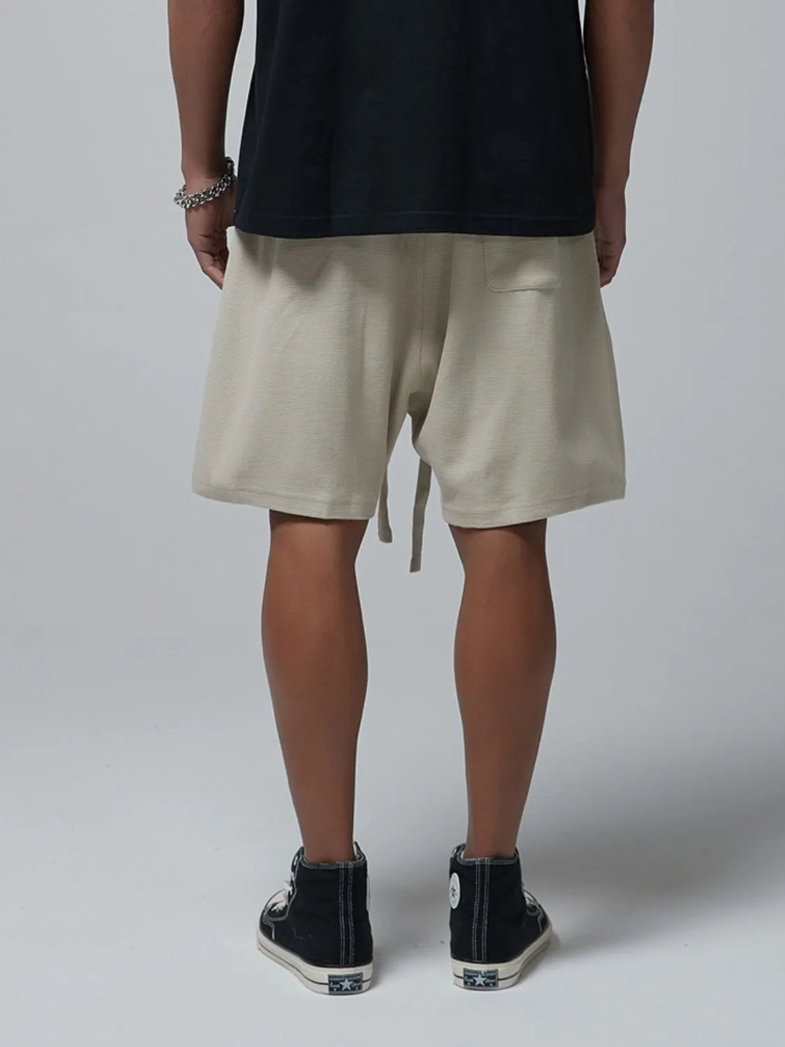 Men's beige waffle shorts with drawstring tie and side pockets, back view