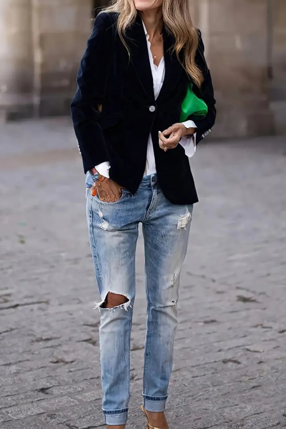 Dark navy one-button lapel blazer with long sleeves and notched lapels, worn open.