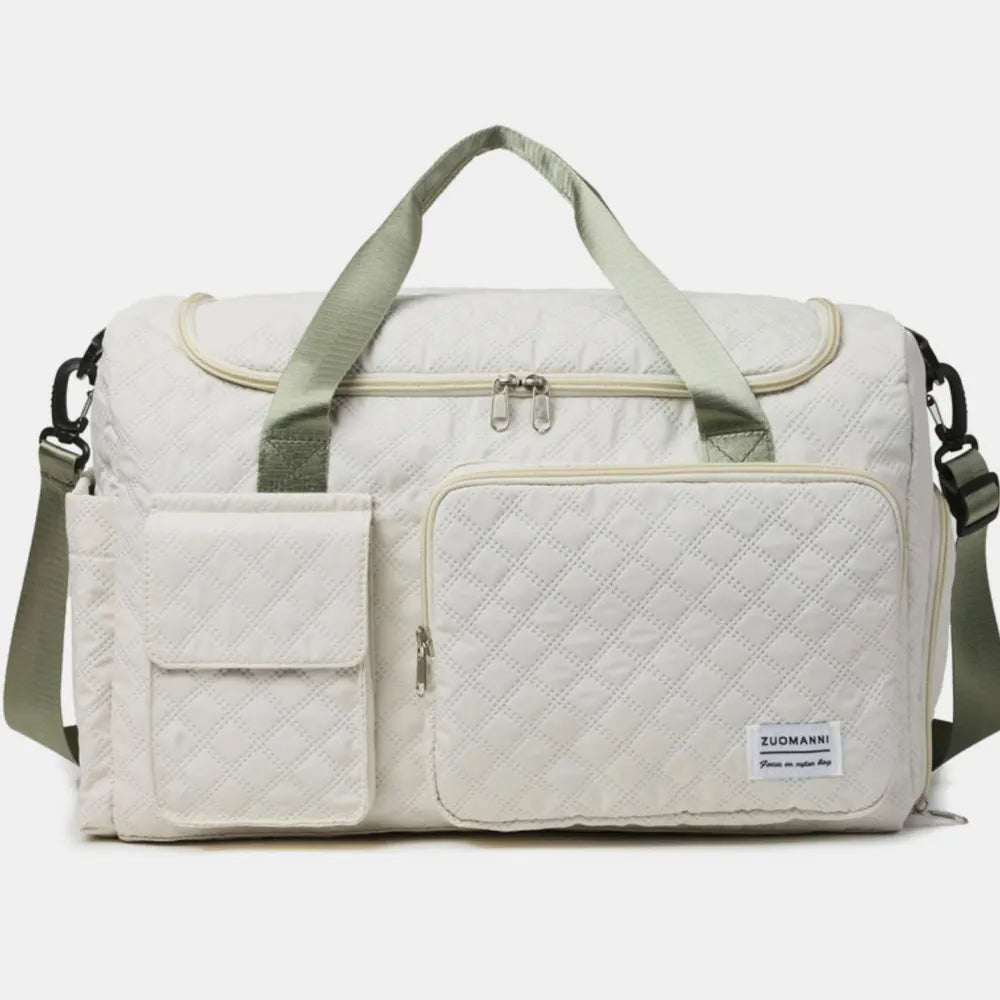 White duffel travel bag with padded handles, crossbody strap, and zip pockets