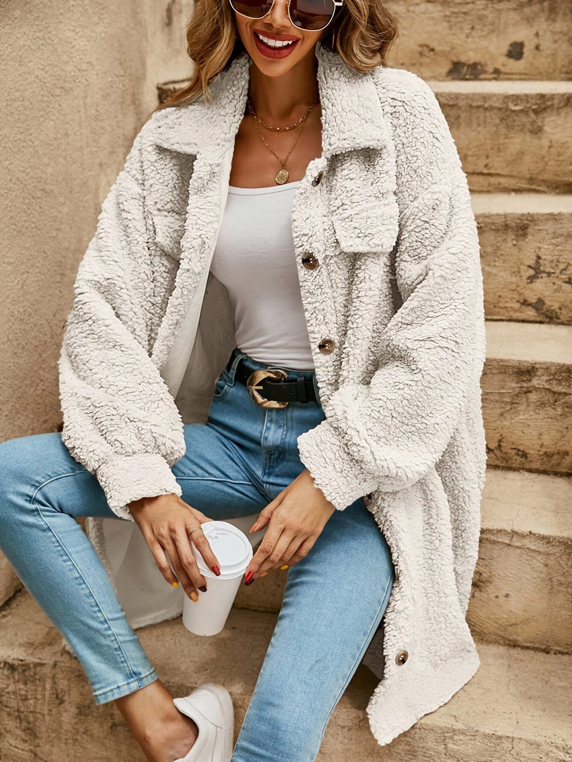 Light tan collared button-down sherpa coat with chest flap pockets and button front
