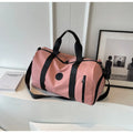 Dusty pink large waterproof duffel bag with black handles and front zipper pocket
