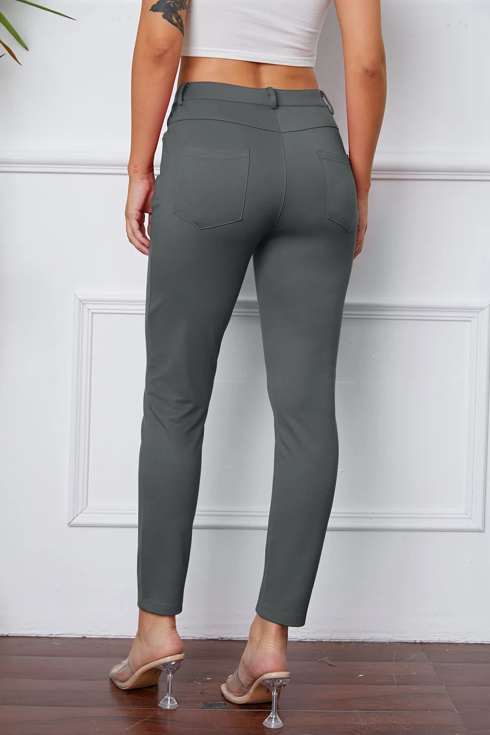 Women's dark gray stretch pants with belt loops, front pockets, and ankle length
