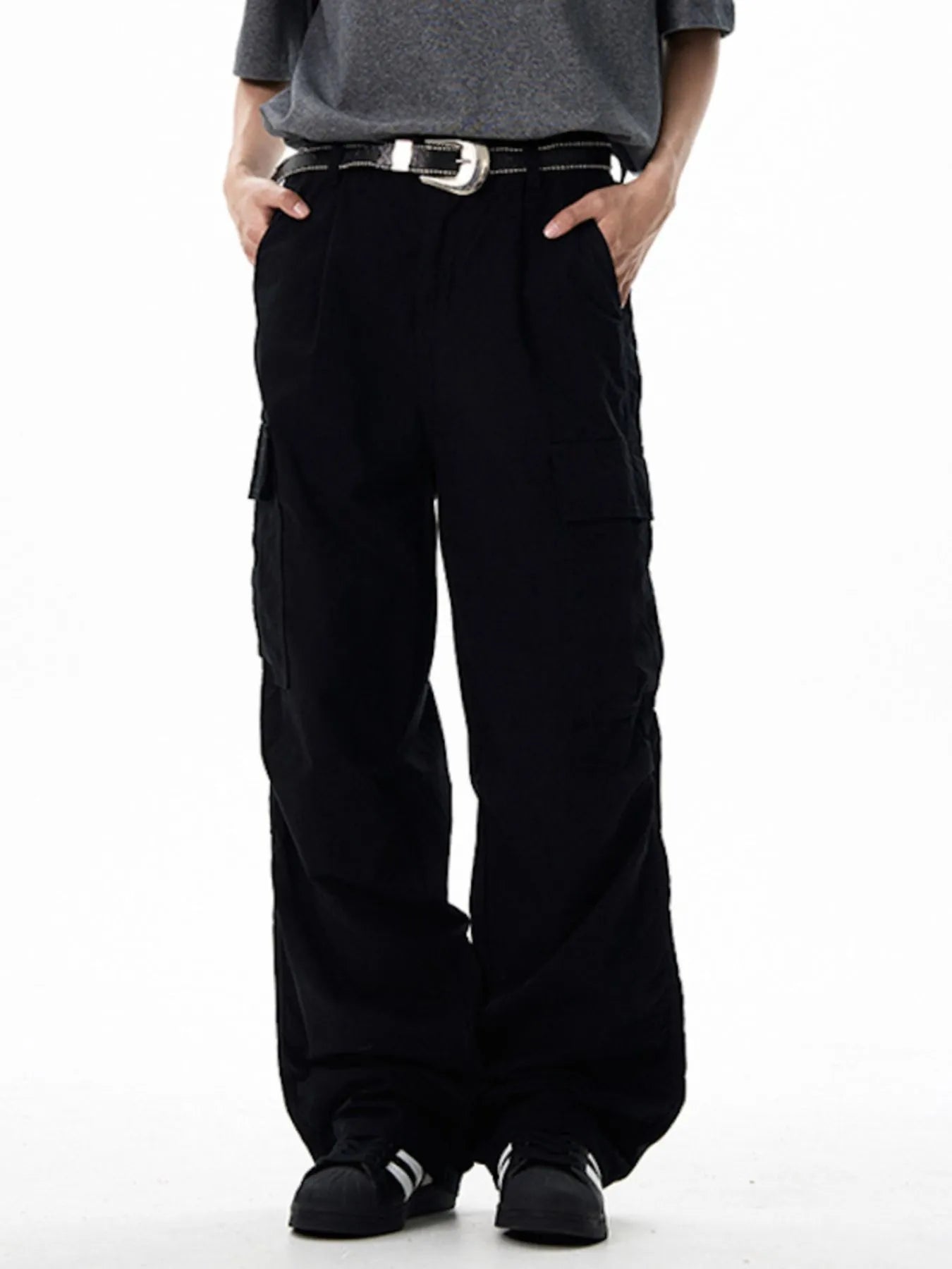 Black wide-leg cargo pants with front button closure and large cargo pockets