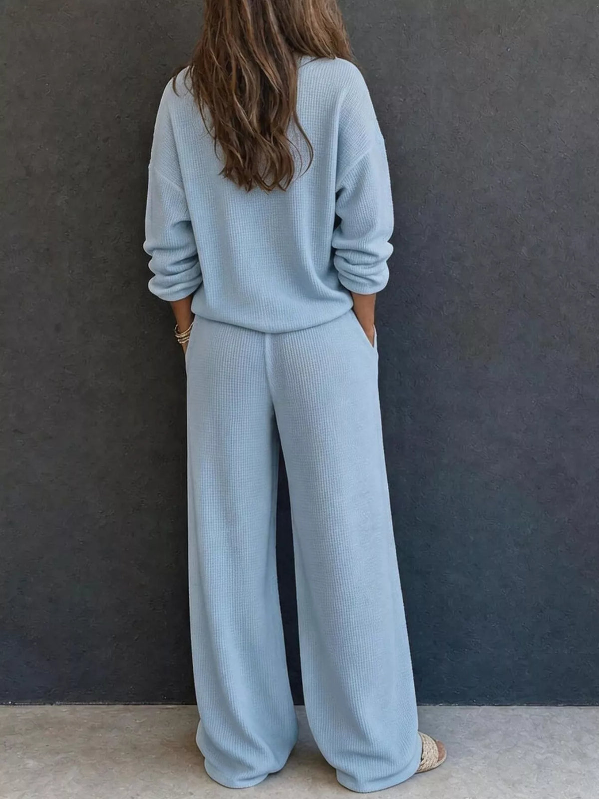 Blue waffle-knit lounge set with long sleeves and relaxed wide-leg pants, back view.