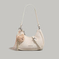 Crescent Shoulder Bag, mini cream PU with teddy bear charm and adjustable strap