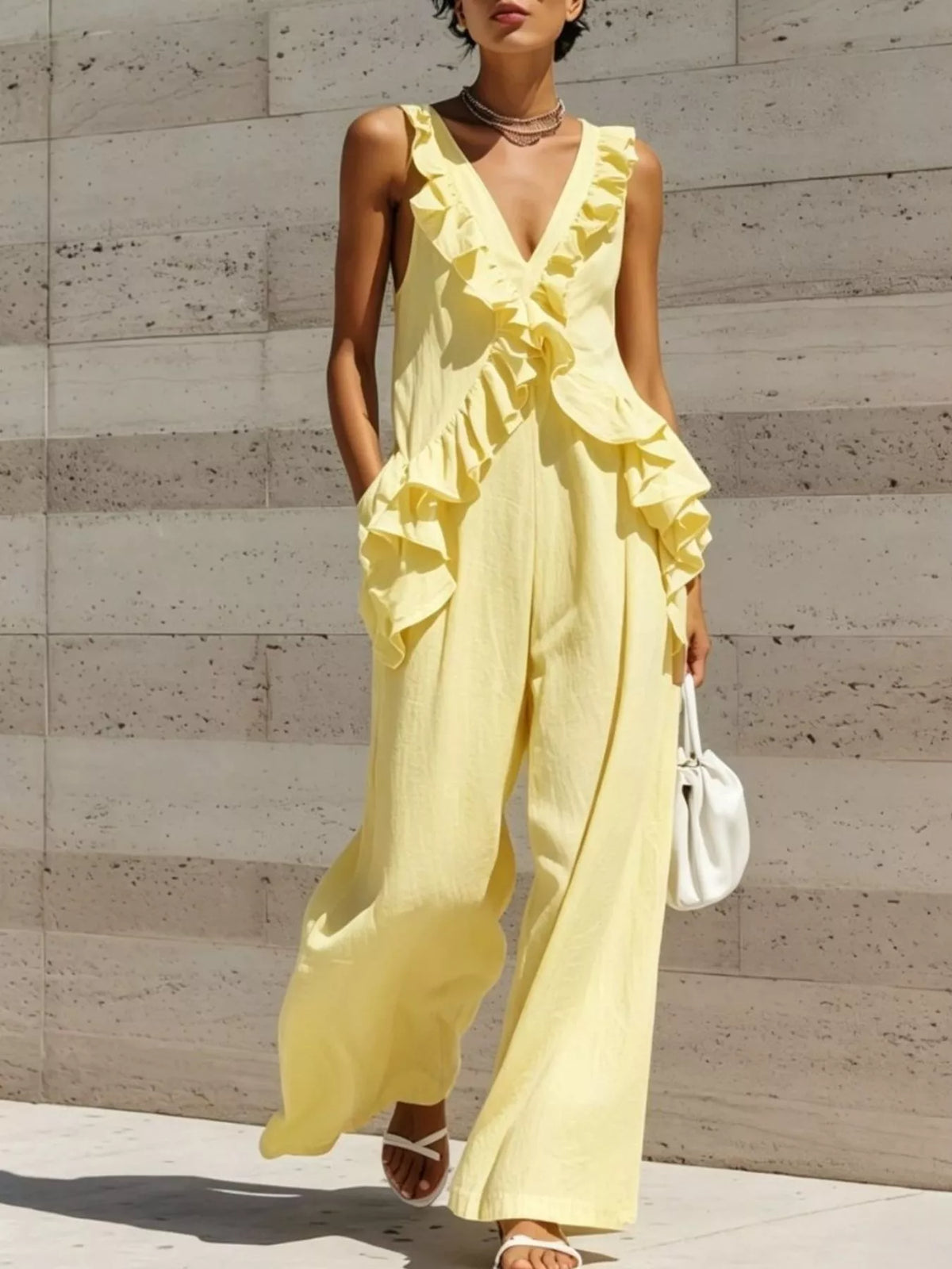 Yellow ruffled V-neck sleeveless jumpsuit with tiered ruffle front and wide-leg silhouette