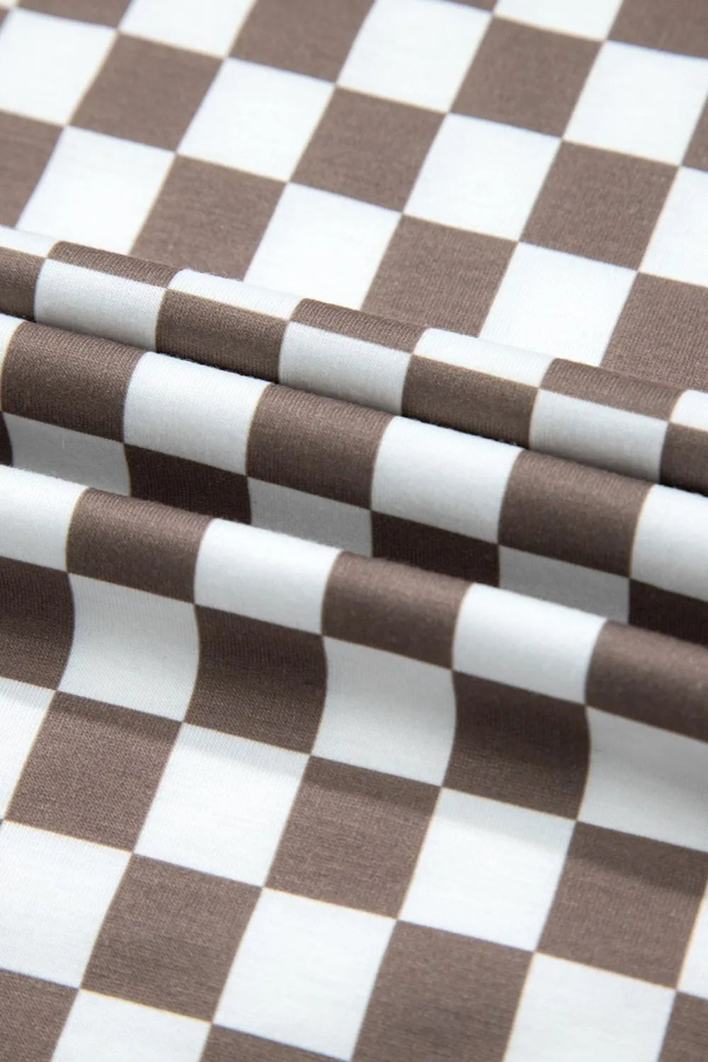 Brown-and-white checkered fabric close-up with repeating square pattern