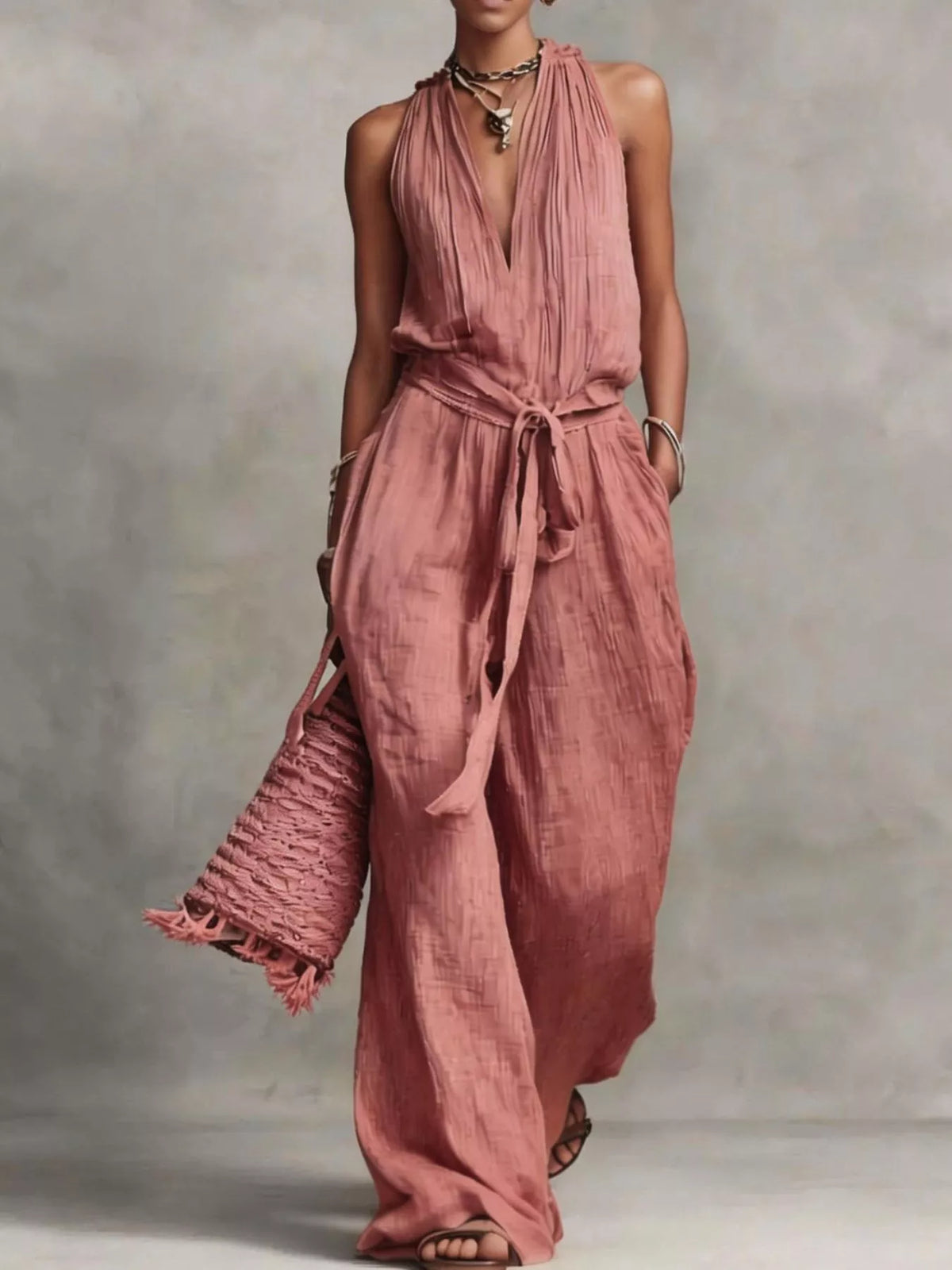 Dusty pink sleeveless wide-leg jumpsuit with V-neck and tie waist belt