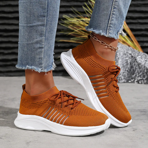 Orange breathable mesh lace-up sneakers with white cushioned sole, side view