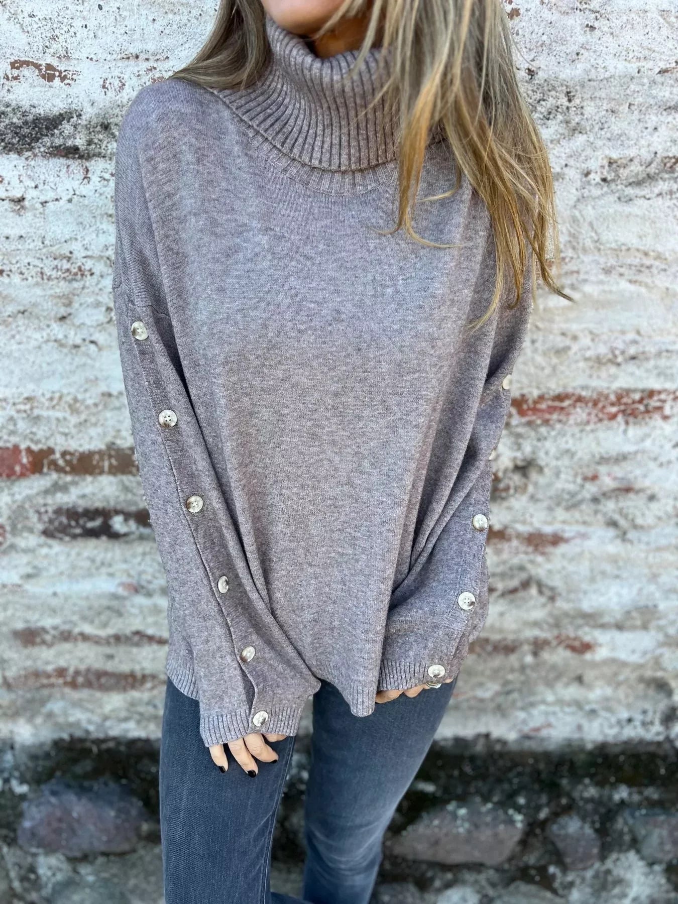 Dark gray turtleneck long-sleeve sweater with ribbed collar and buttoned cuffs