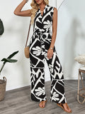 Printed wide-leg jumpsuit, sleeveless V-neck, black-and-white abstract print.