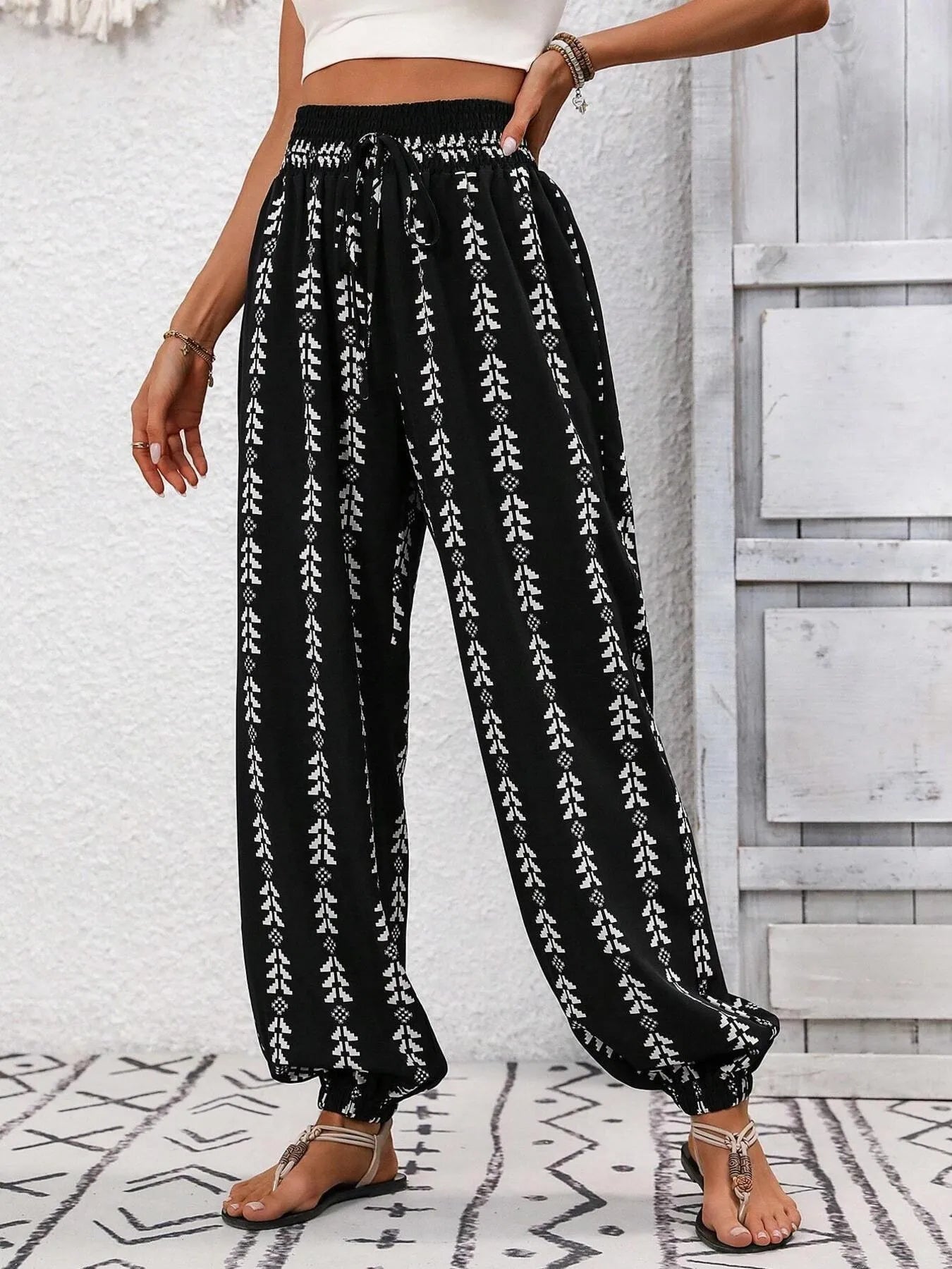 Wide-leg printed pants, black with white vertical motif and elastic smocked waistband