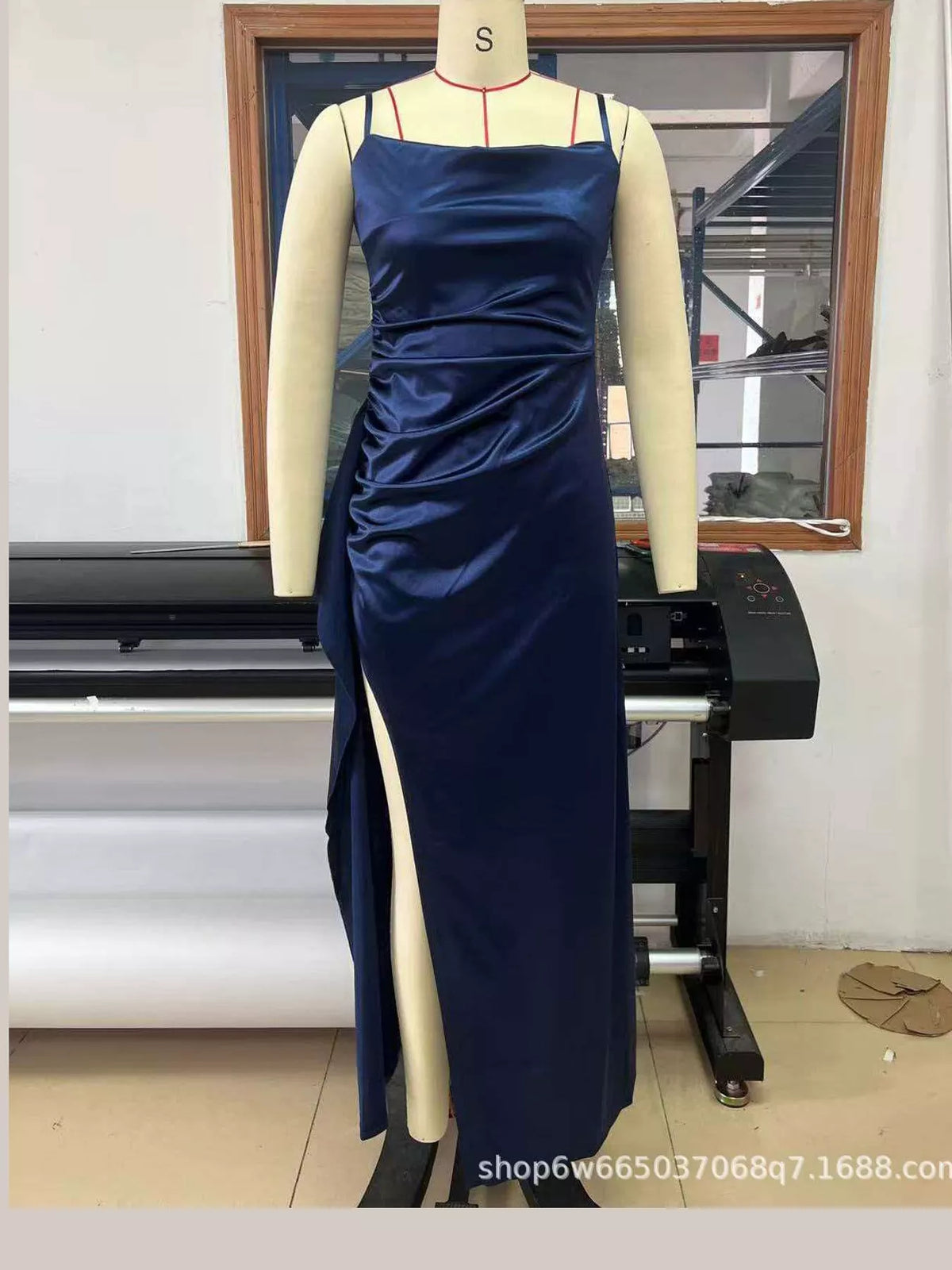 Dark blue satin maxi dress on hanger: ruched bodice, spaghetti straps, draped side slit.
