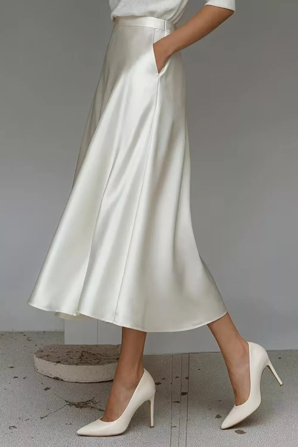 White satin A-line midi skirt with side pockets, wide waistband and full skirt