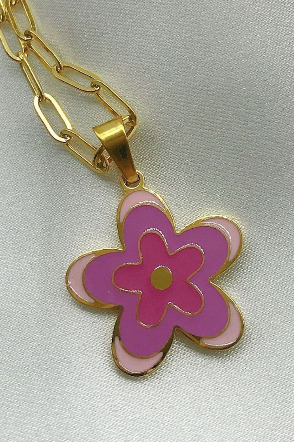 Gold-tone flower pendant necklace with purple enamel flower and bronze center