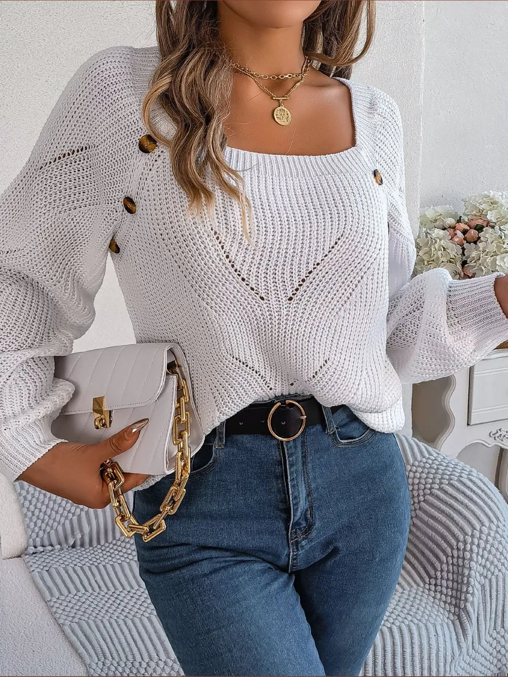 White openwork knit sweater with square neck, textured pattern, and buttoned shoulders