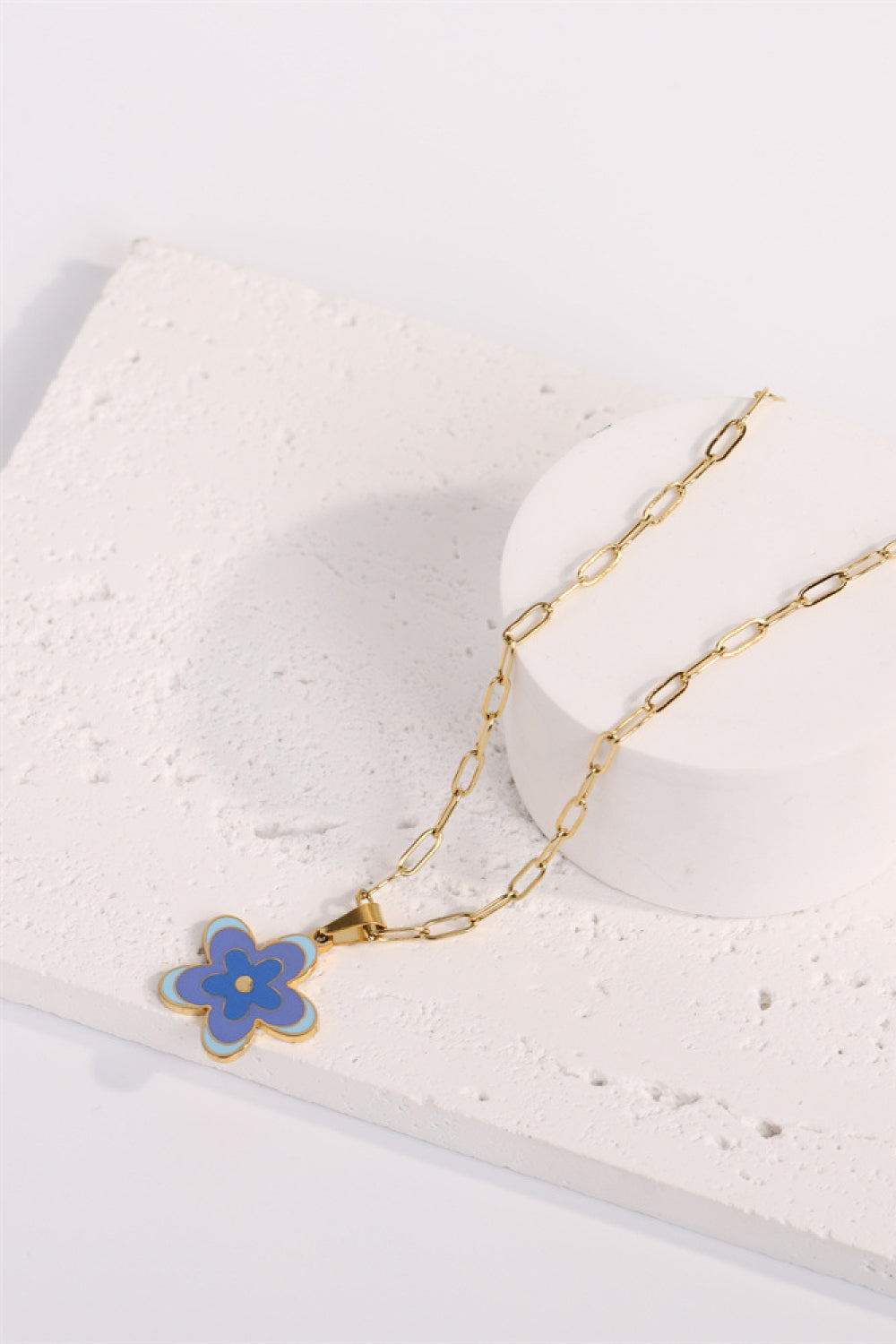 Gold-tone flower pendant necklace with blue enamel flower charm