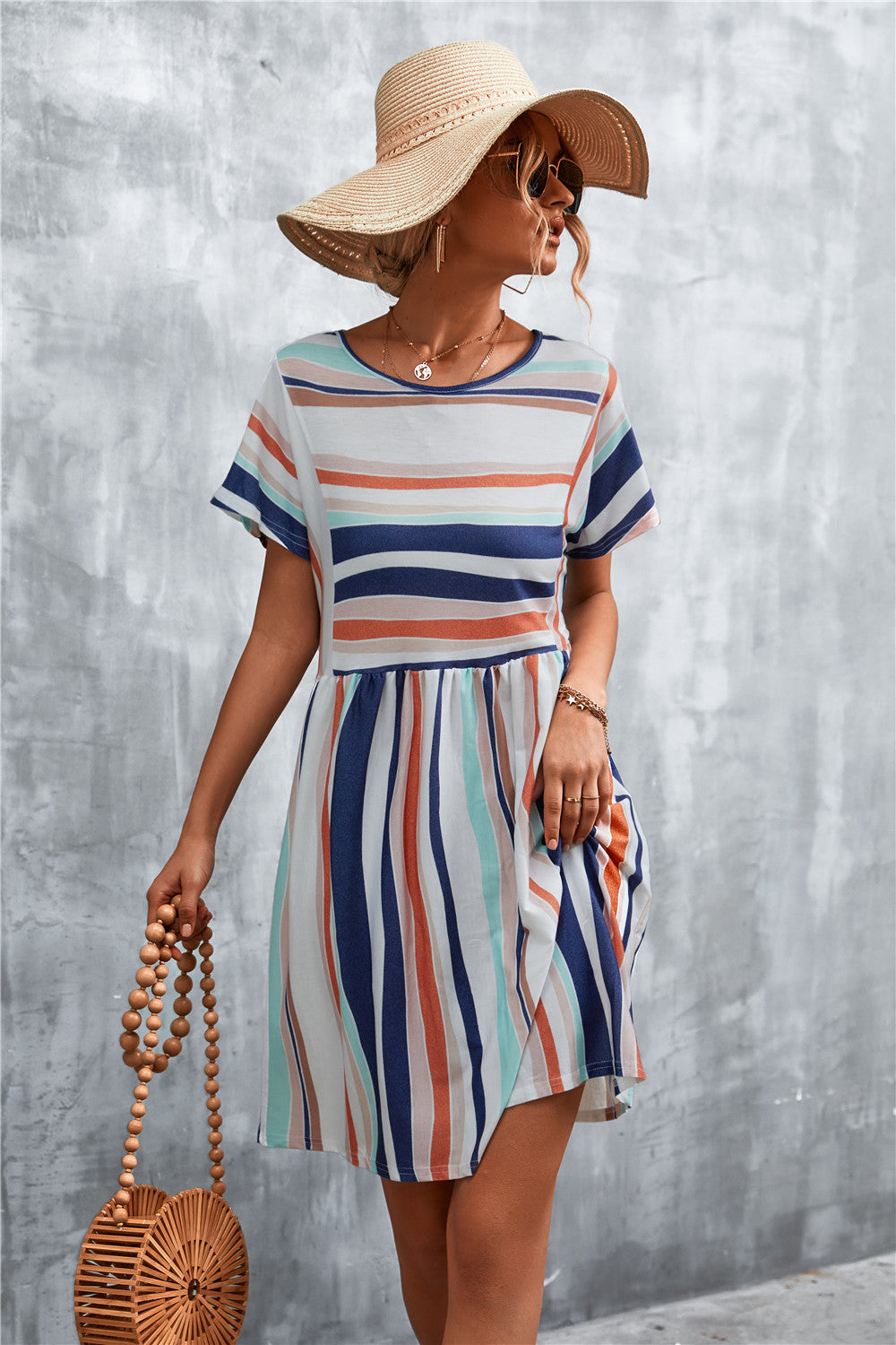 Striped round-neck dress with short sleeves and gathered waist, blue and coral vertical stripes