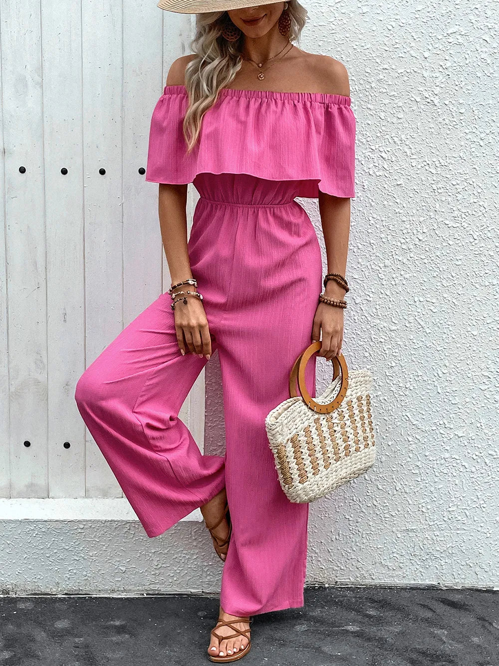 Hot pink off-shoulder wide-leg jumpsuit with ruffled neckline and gathered waist