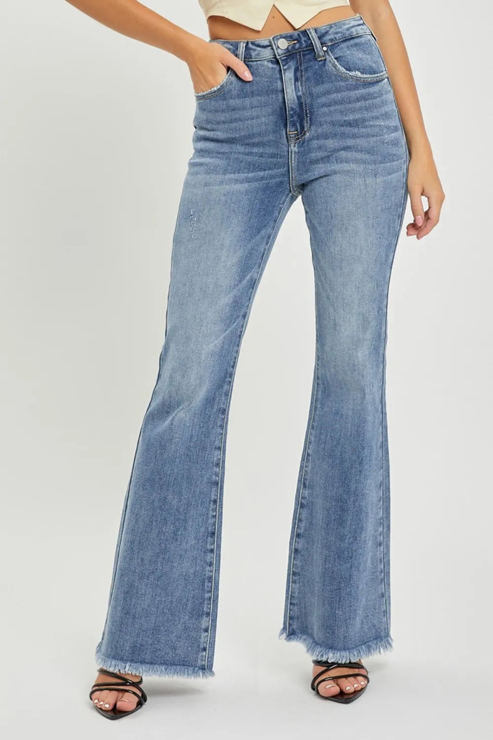High-waist flare jeans with raw hem, medium blue wash, button fly, front pockets