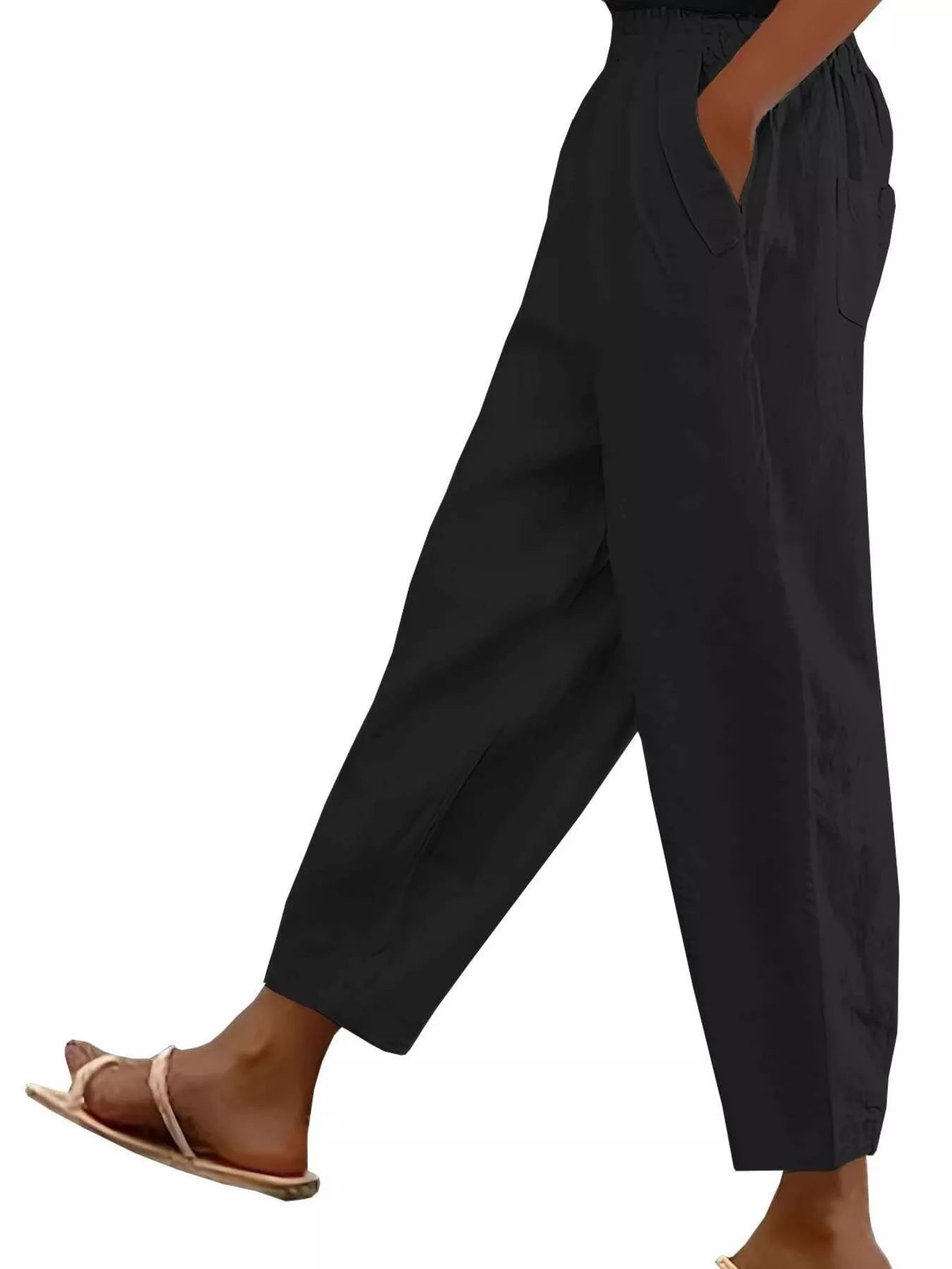 Black loose-fit polyester pants with front pockets and tapered cuffs
