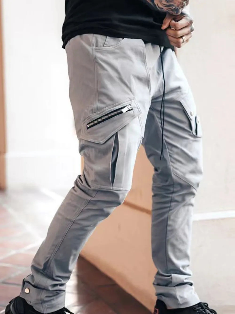 Men's plus size cargo pants in gray with side cargo pockets and zippered detail