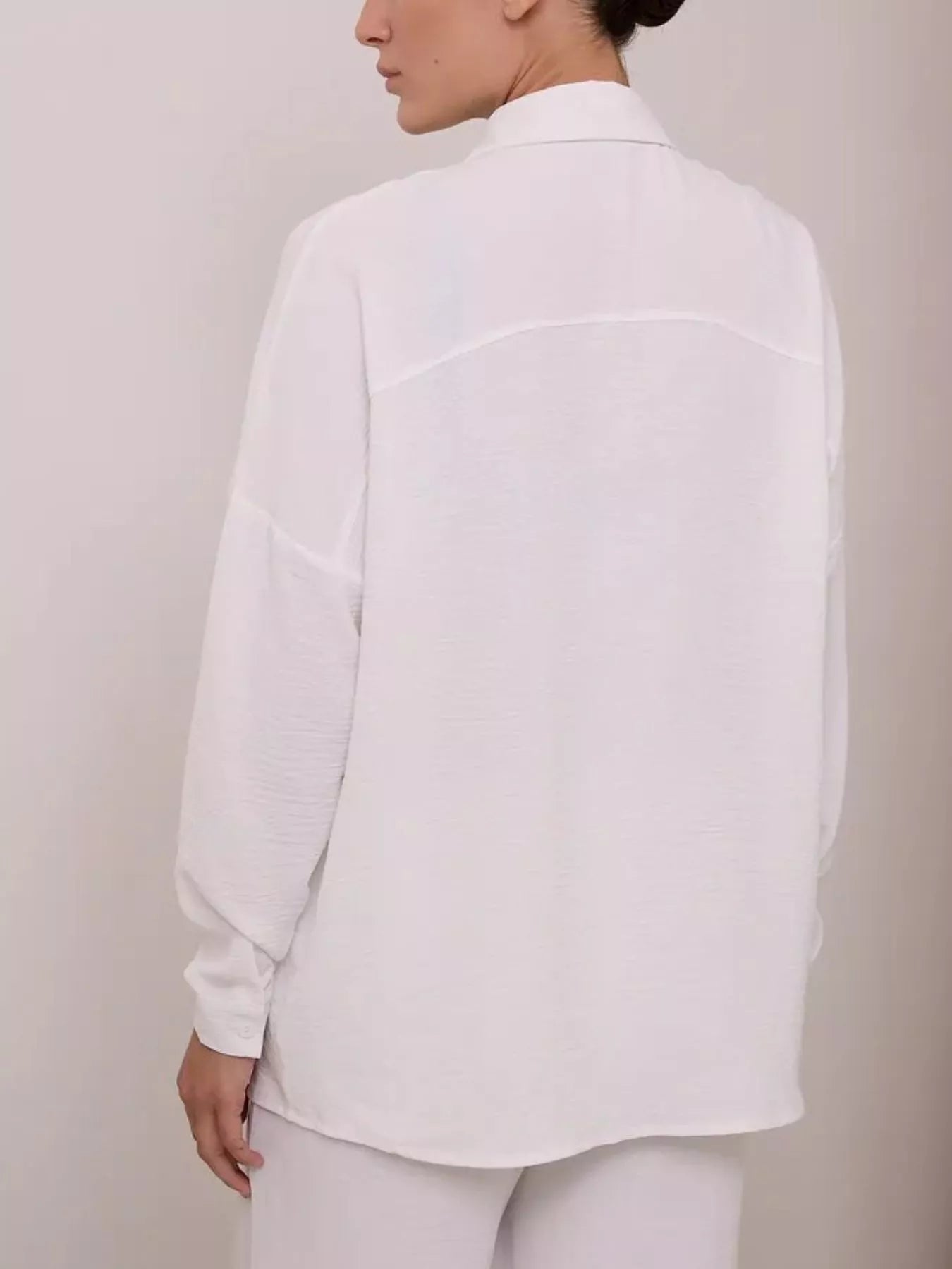 White relaxed shirt and wide-leg pants set, back view of long-sleeve shirt and pants