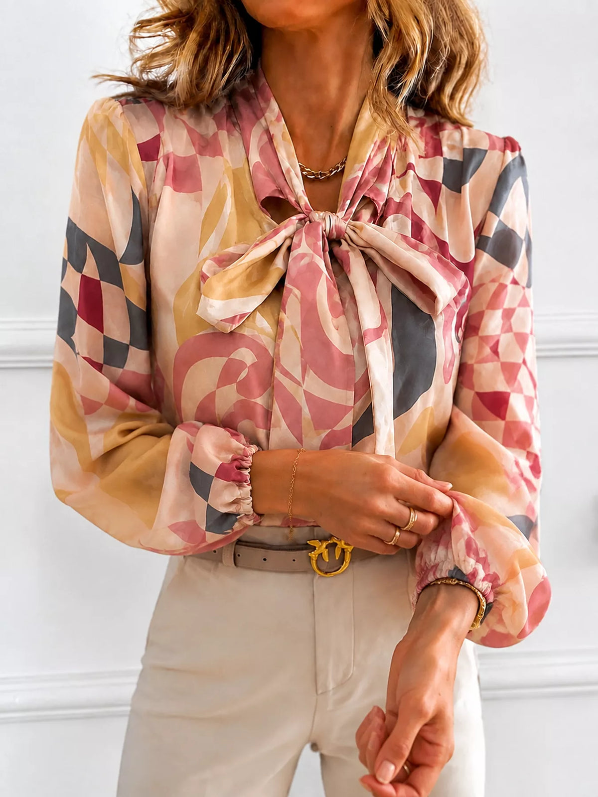 Printed bow-tie neck long-sleeve blouse with long puffed cuffs and pink check accents