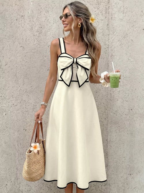 Beige A-line midi dress featuring a bowknot detail at the bust with black edging.