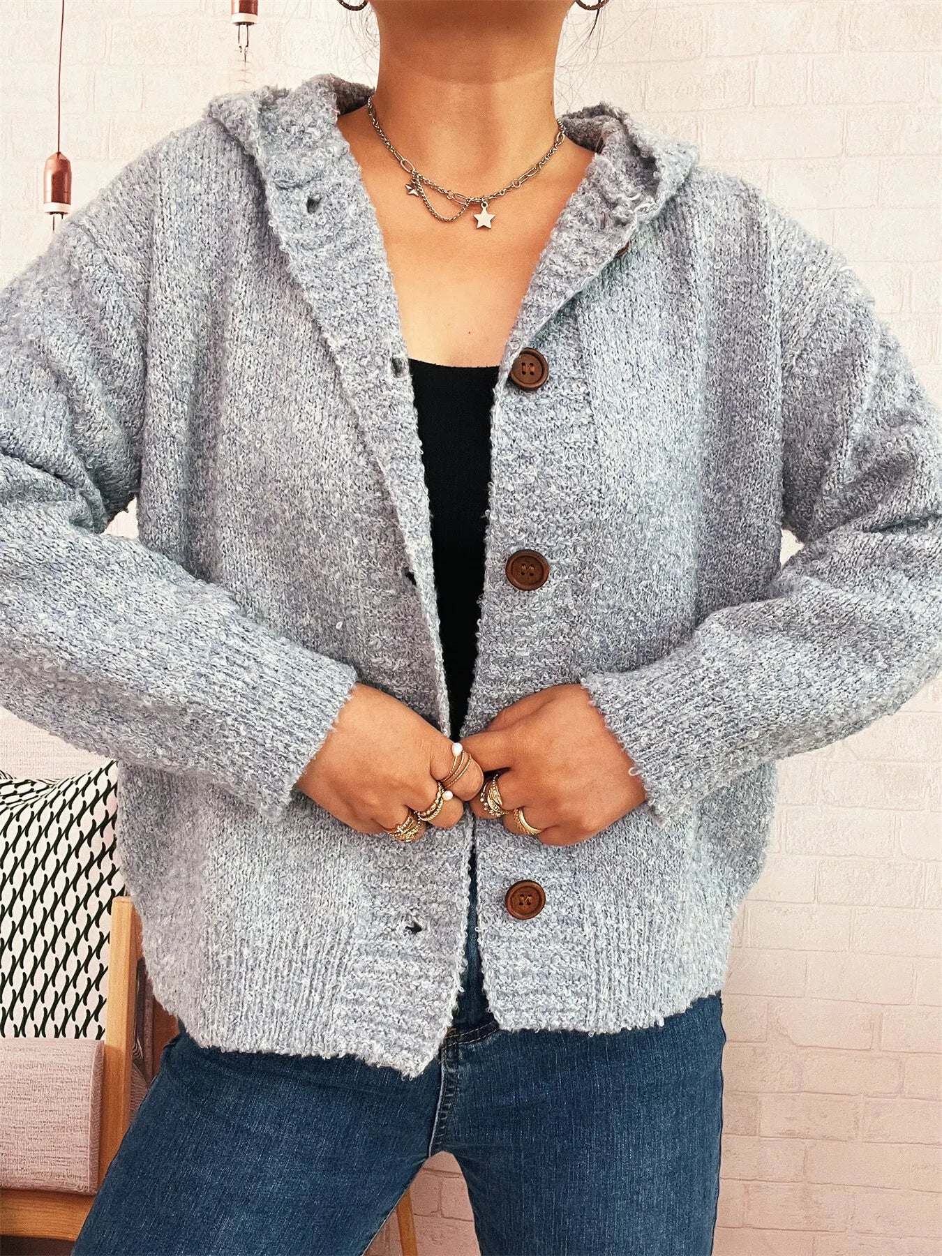 Cozy hooded cardigan, heather gray textured knit with button closure and hood.