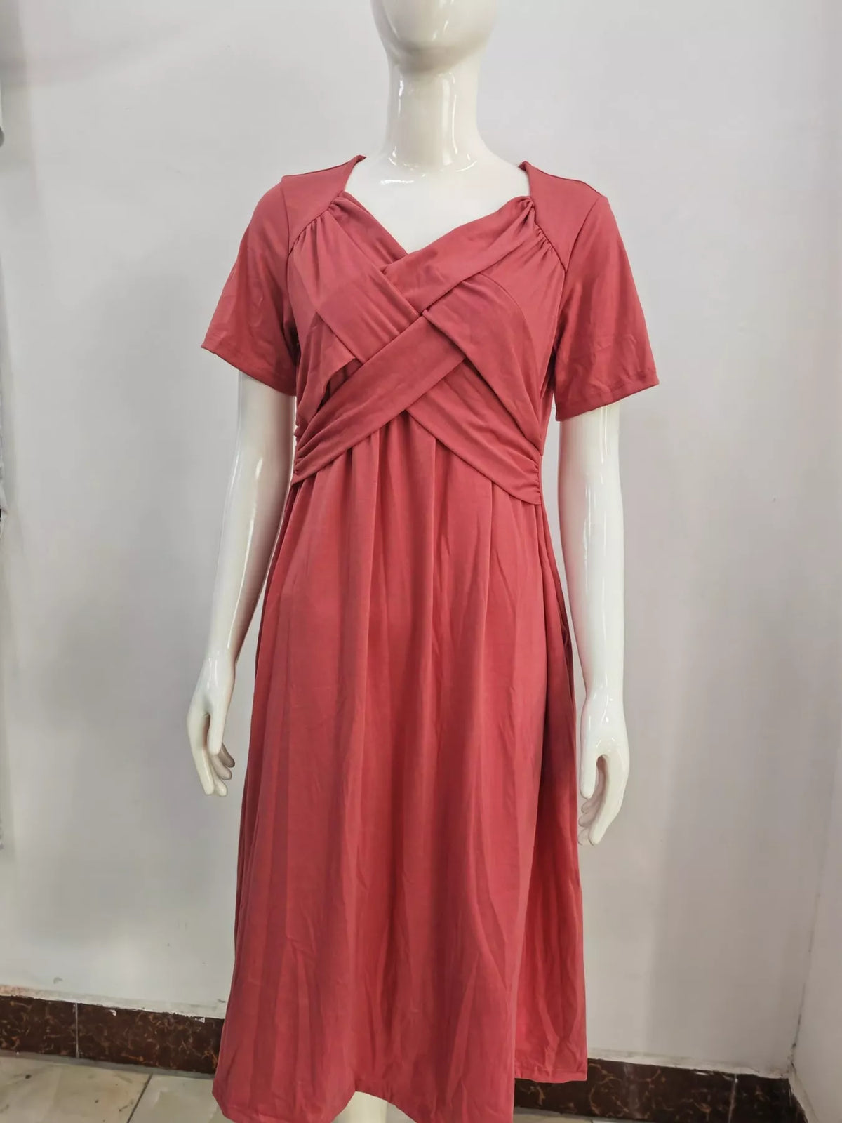 Watermelon red midi dress on mannequin with crisscross V-neck and short sleeves