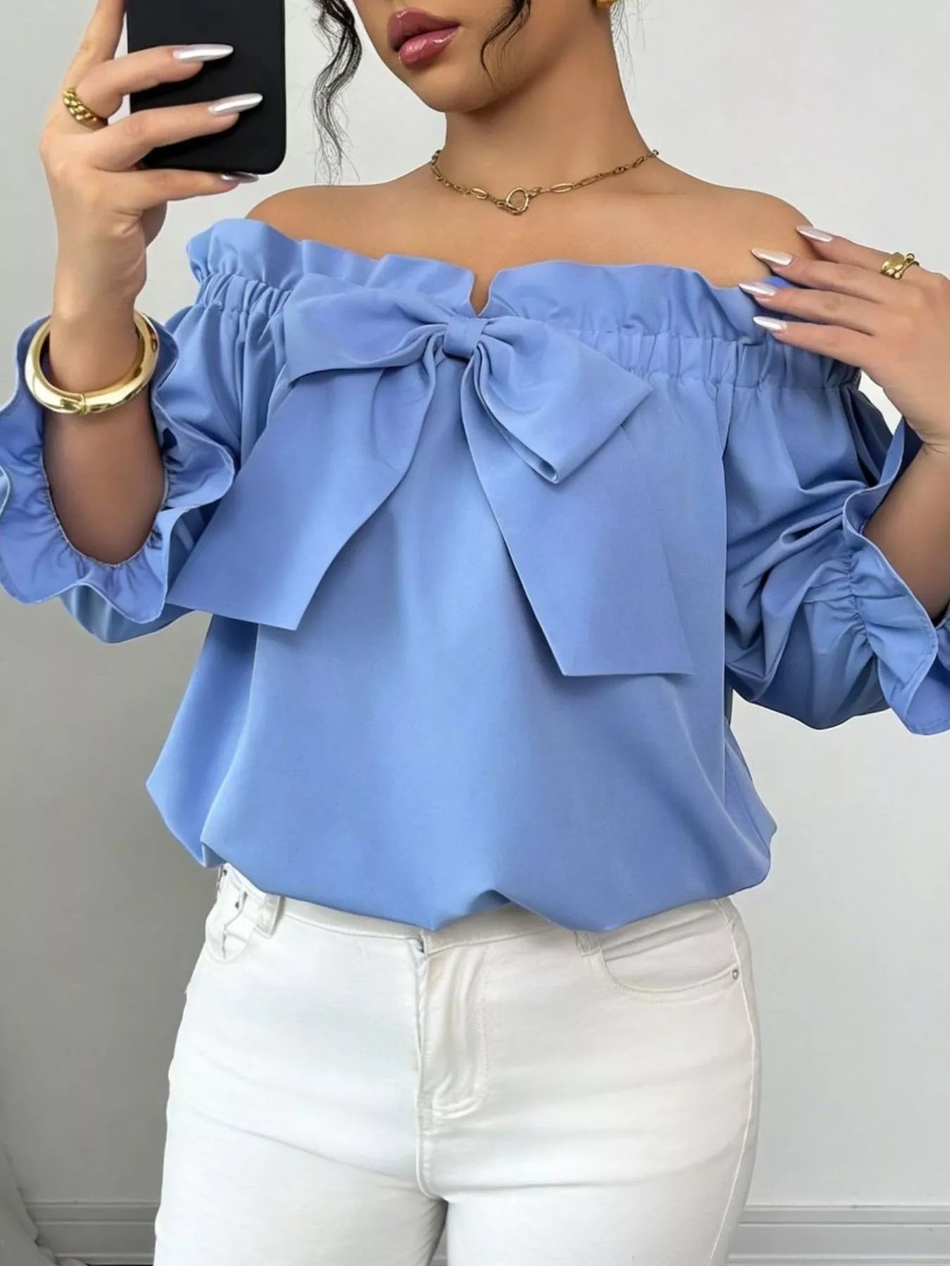 Bow Flounce Sleeve Blouse in light blue by Trendsi, off-shoulder neckline with large front bow and puff sleeves.