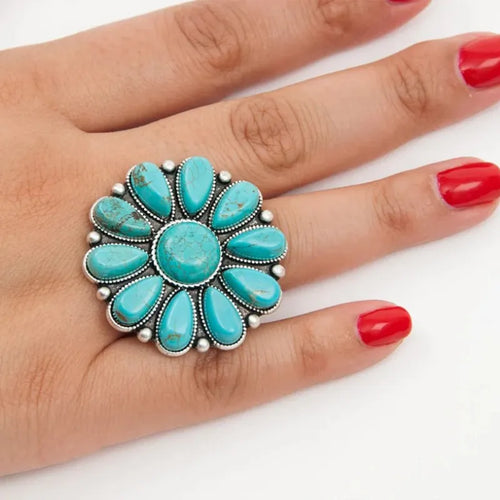 Turquoise flower-shaped alloy ring with oval turquoise stones and silver bead trim
