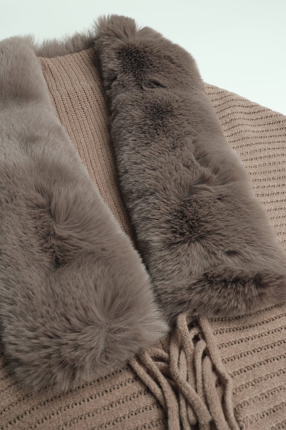 Long-sleeve ribbed poncho with fringe trim, taupe, fur-lined collar close-up