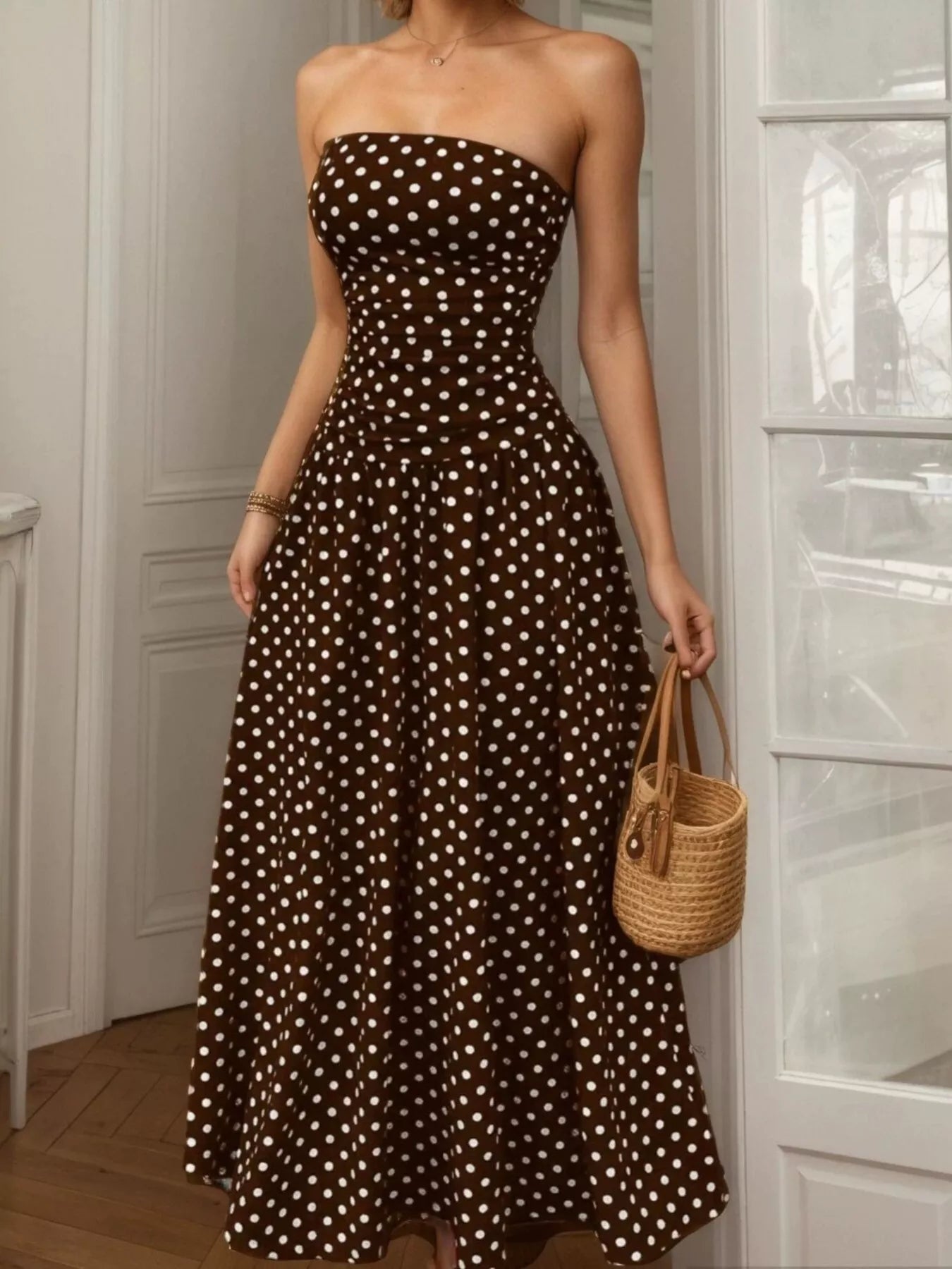 Dark brown strapless maxi dress with light polka dots, fitted bodice and full skirt
