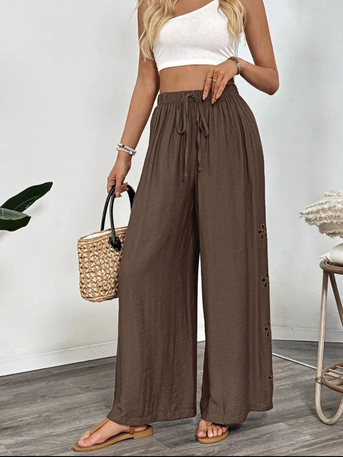 Dark brown wide-leg pants with elastic waist and small side embroidered cutouts