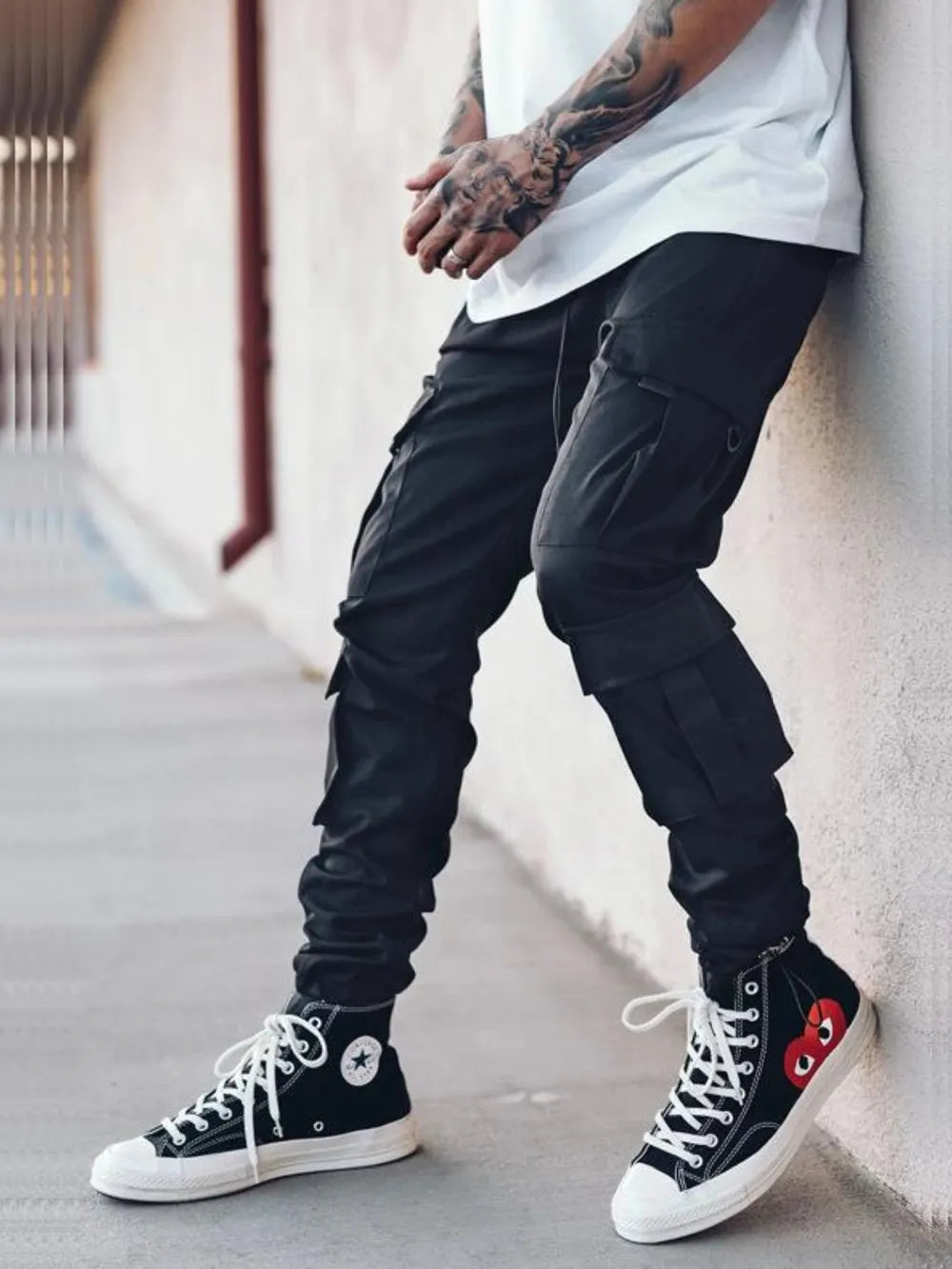 Men's black drawstring cargo pants with side cargo pockets and ankle cuffs