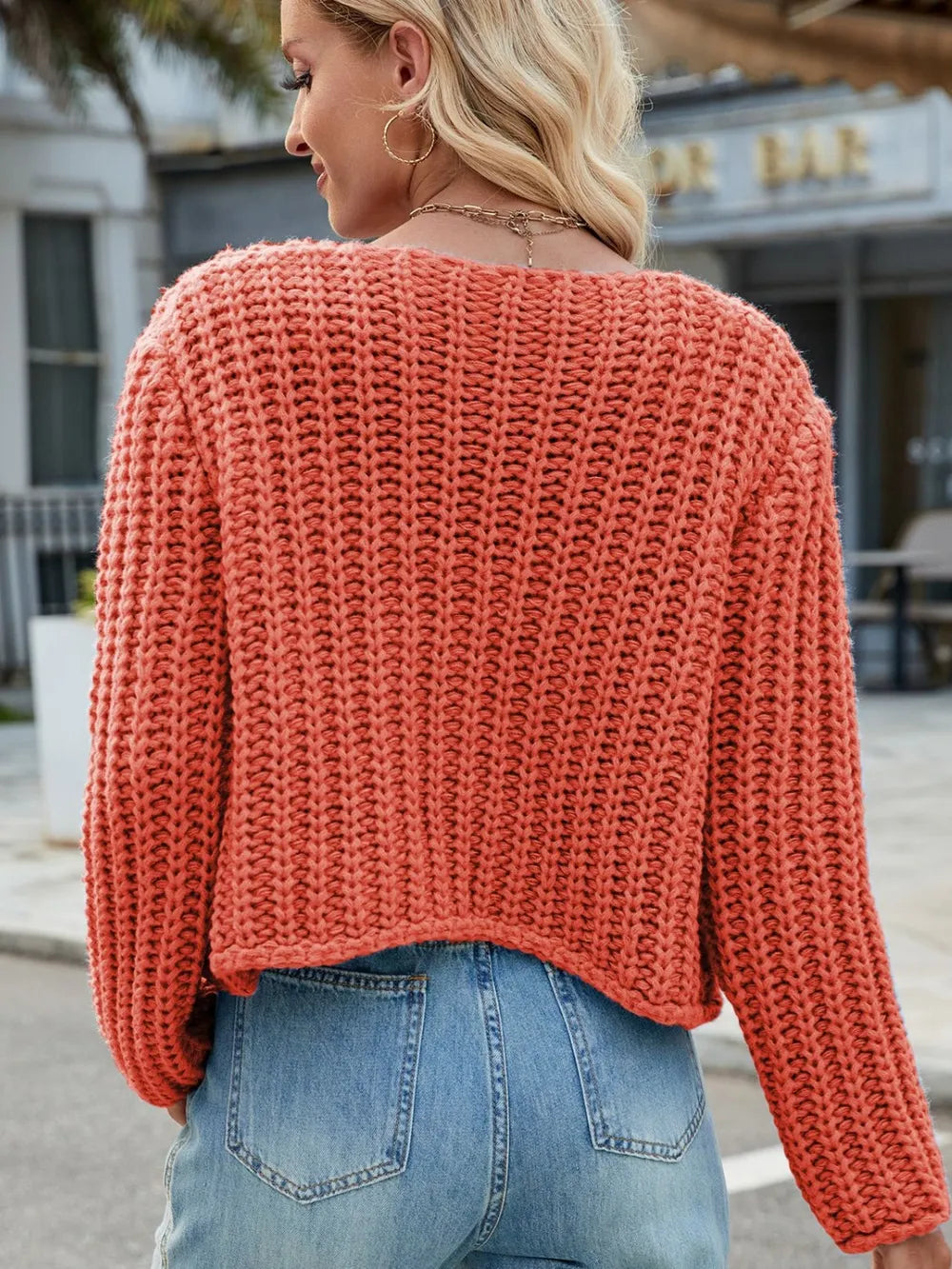 Coral orange round-neck button-up cardigan back view with textured knit