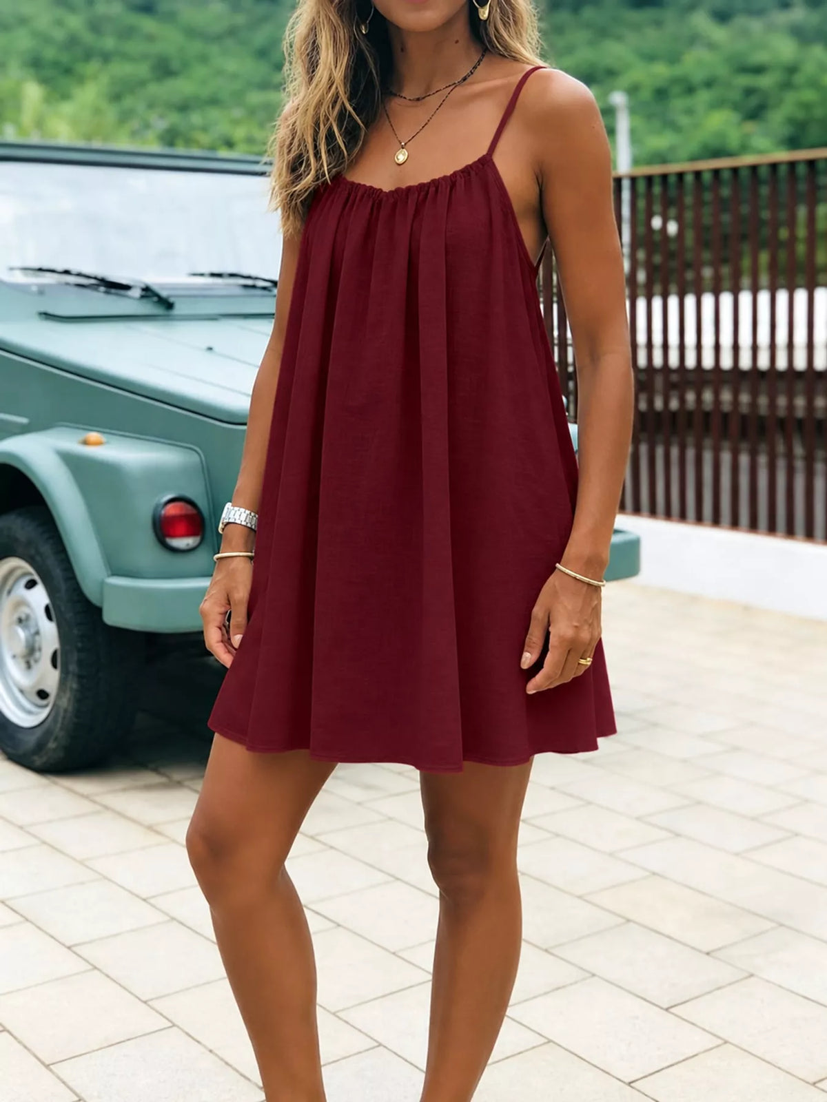 Burgundy ruched spaghetti strap mini dress with gathered bodice and pleated skirt