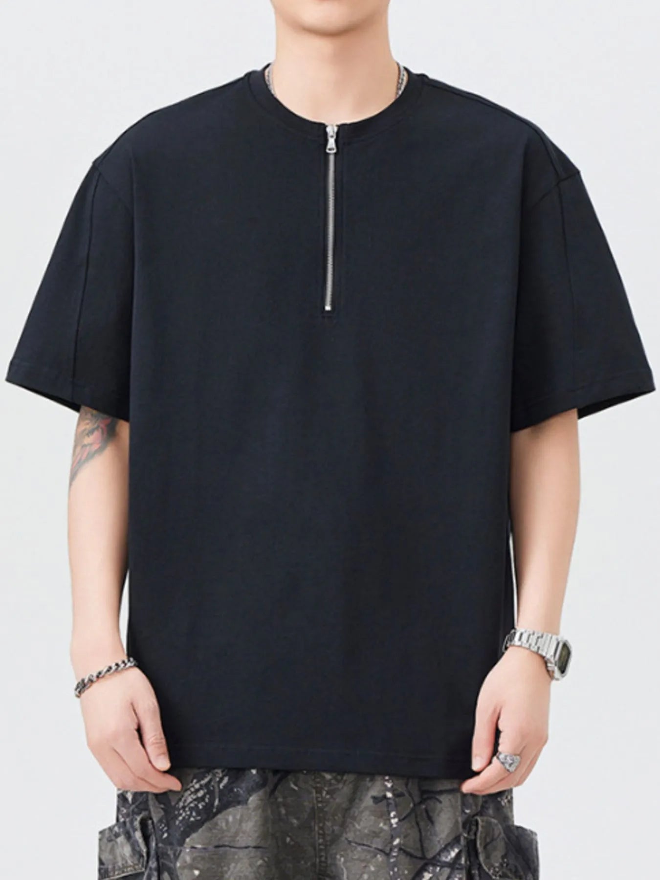 Black oversized half-zip T-shirt with short sleeves and front zipper