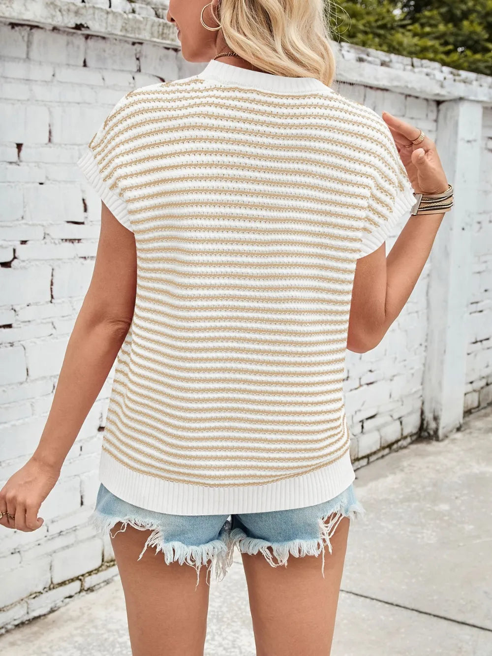 Back of cream-and-tan striped cap-sleeve sweater with round neck and ribbed hem