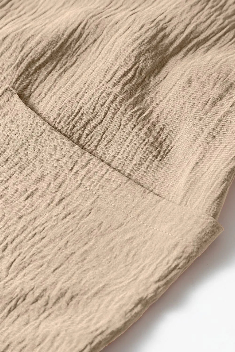 Khaki jumpsuit fabric with diagonal seam and textured weave