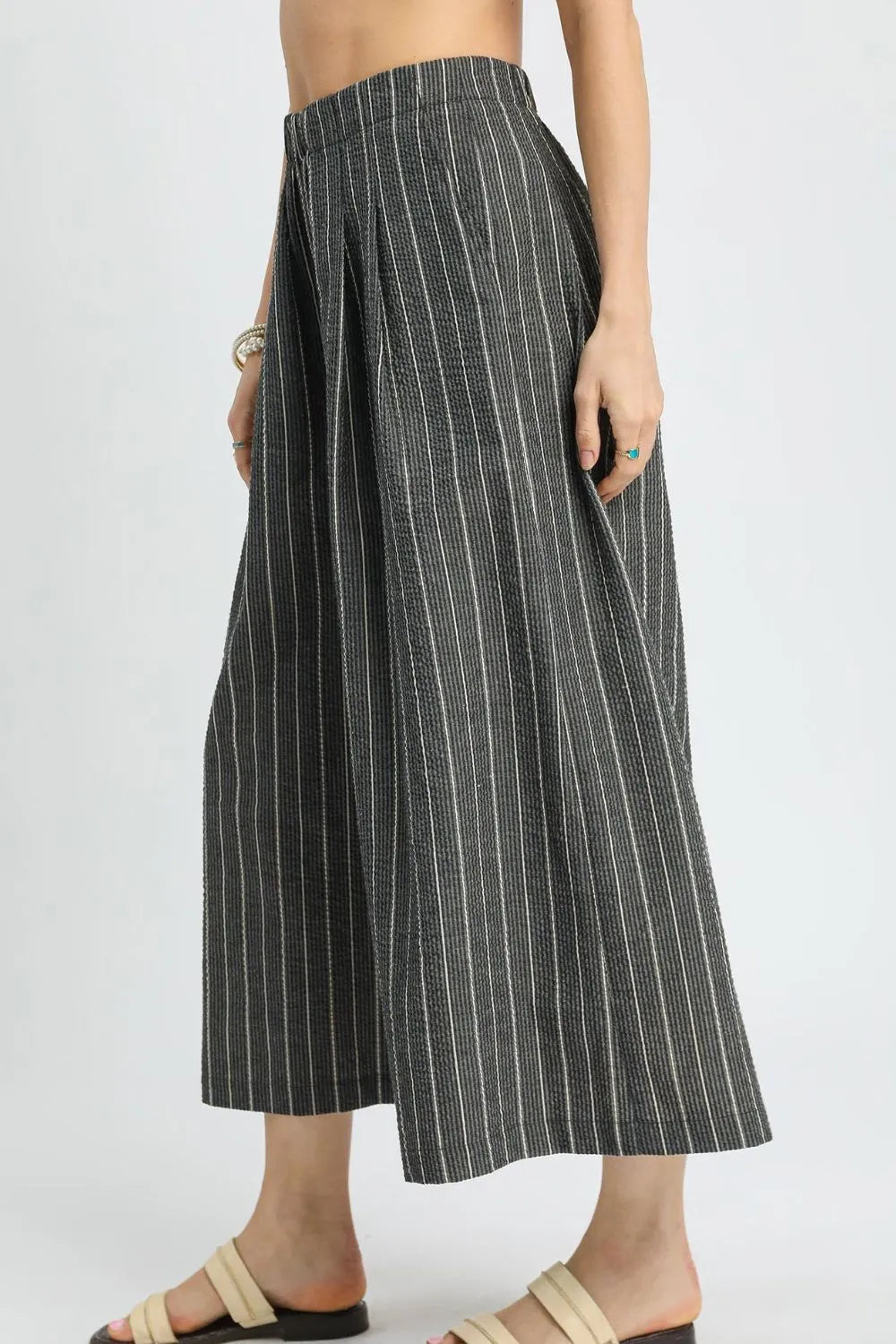 Pinstripe crop palazzo pants with vertical stripes and elastic waistband, draped wide-leg fit
