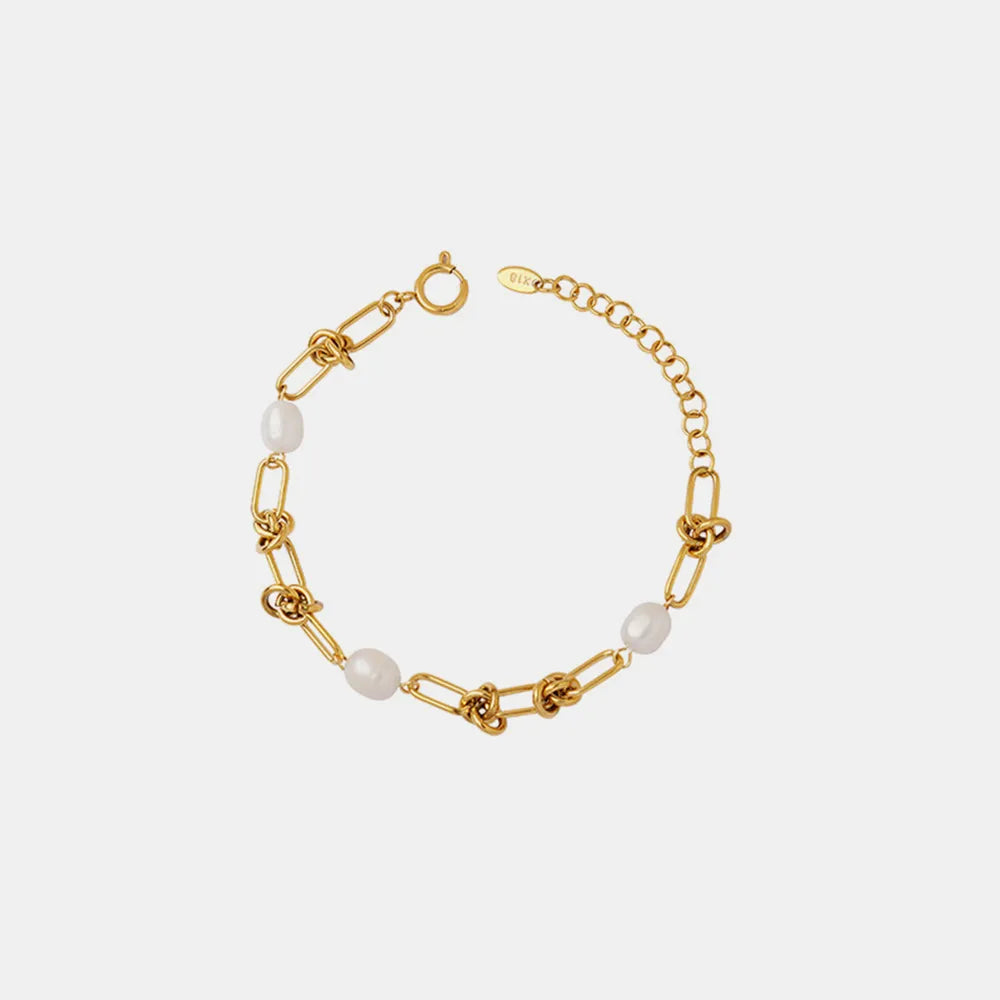 Gold pearl chain bracelet with round beads, clasp ring, and oval link accents